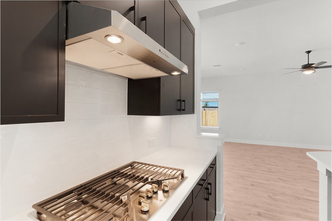 101 Golden Sage Avenue Georgetown, TX 78633 - Photo 4 of 24 a kitchen with a stove and a microwave
