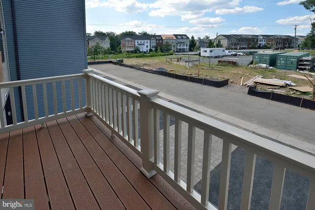 a view of balcony with yard and ocean view