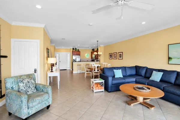 a living room with furniture and a floor to ceiling window