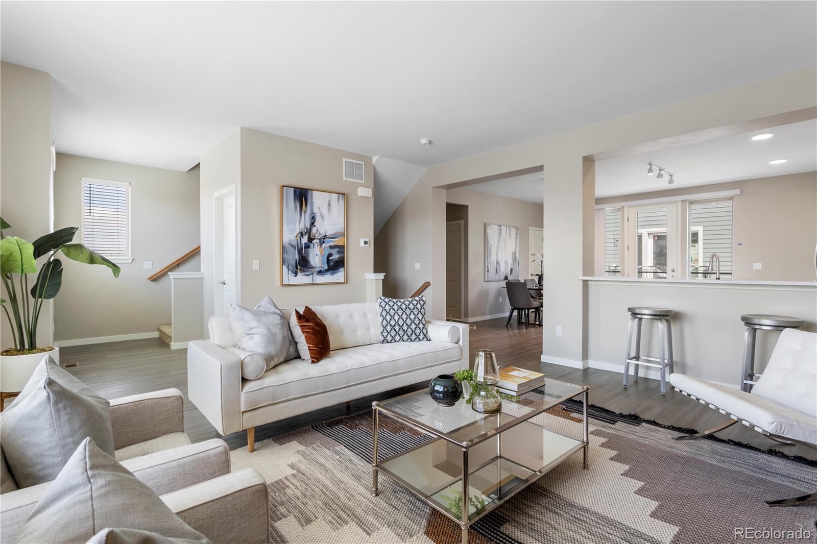 1850 South Quebec Way, Unit 628 Denver, CO 80231 - Photo 1 of 1 a living room with furniture and wooden floor