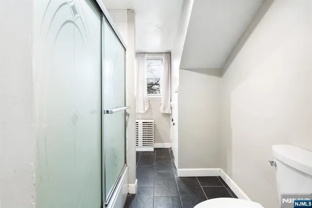 a view of a hallway with wooden floor and entryway
