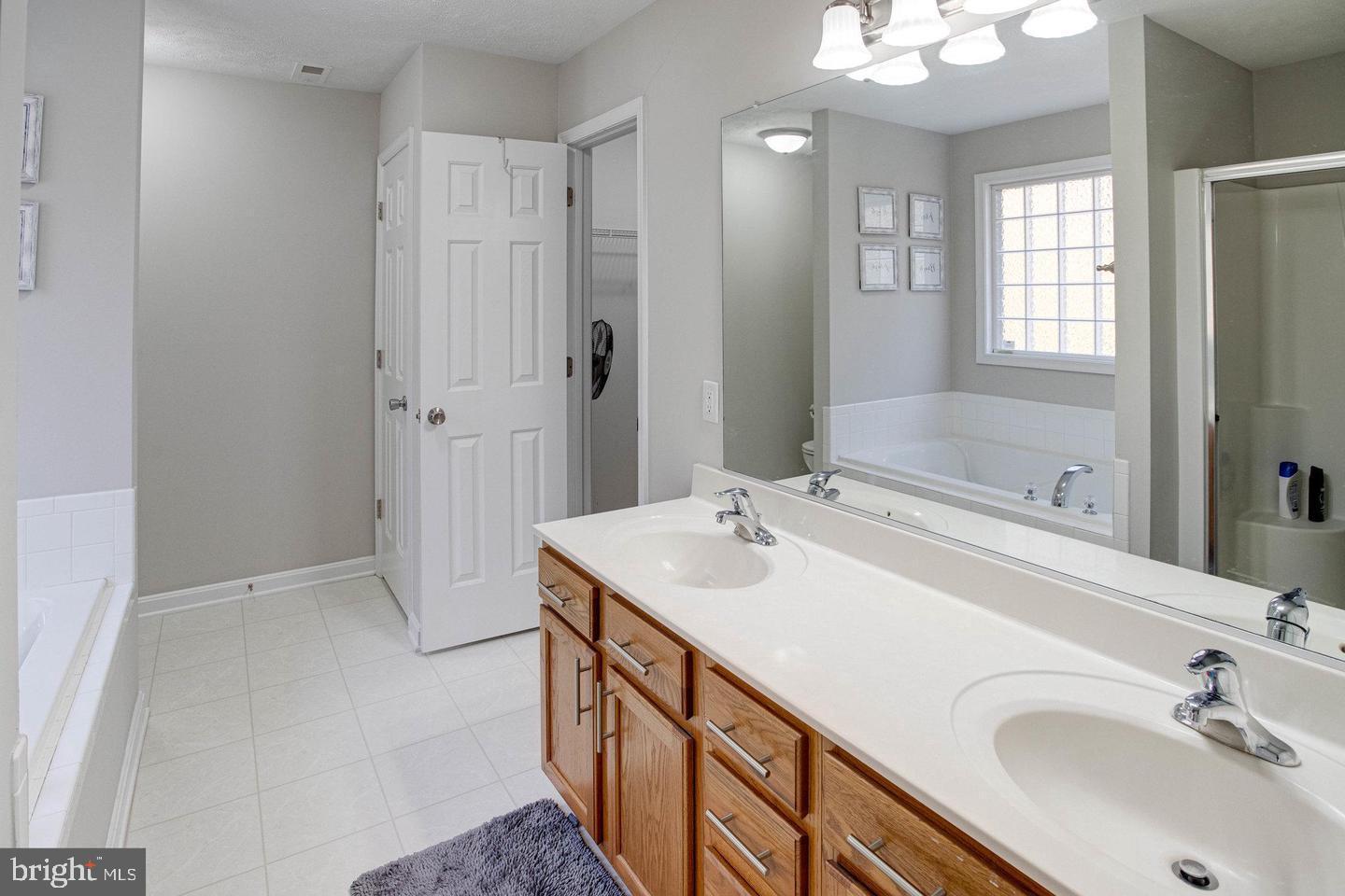 6316 Hams Ford Road Spotsylvania, VA 22551 - Photo 12 of 21 a bathroom with a sink double vanity and a mirror