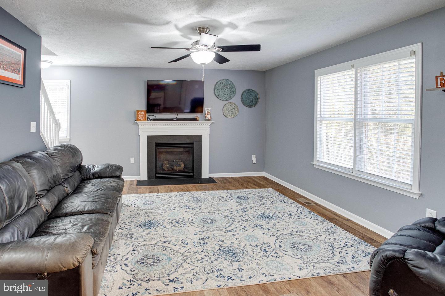 6316 Hams Ford Road Spotsylvania, VA 22551 - Photo 5 of 21 a living room with furniture a flat screen tv and a fireplace
