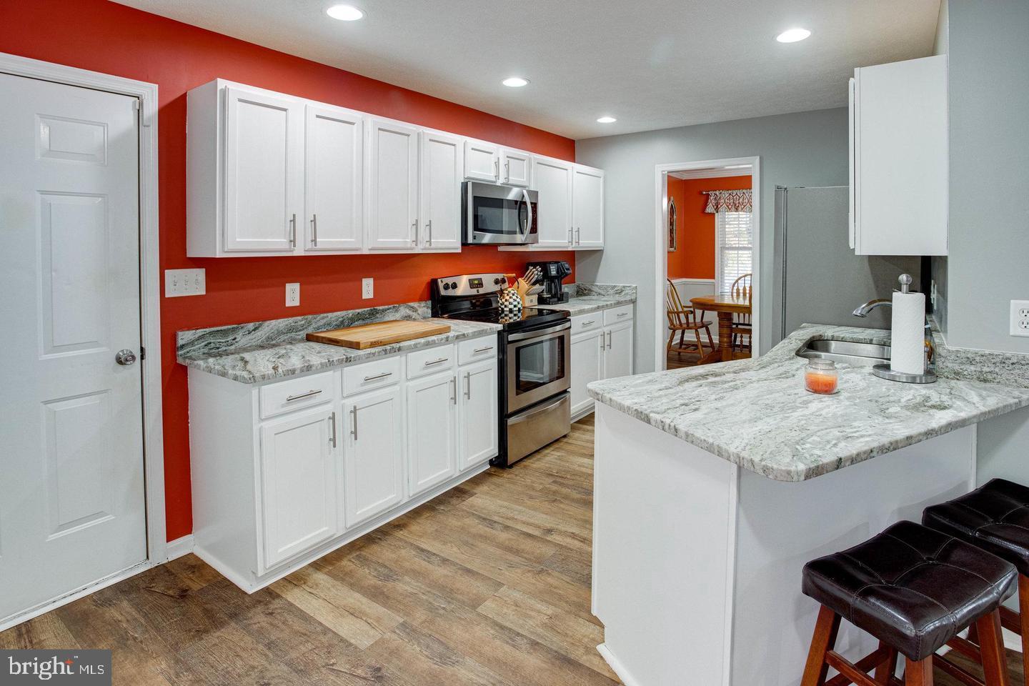6316 Hams Ford Road Spotsylvania, VA 22551 - Photo 6 of 21 a kitchen with stainless steel appliances granite countertop a stove sink and cabinets