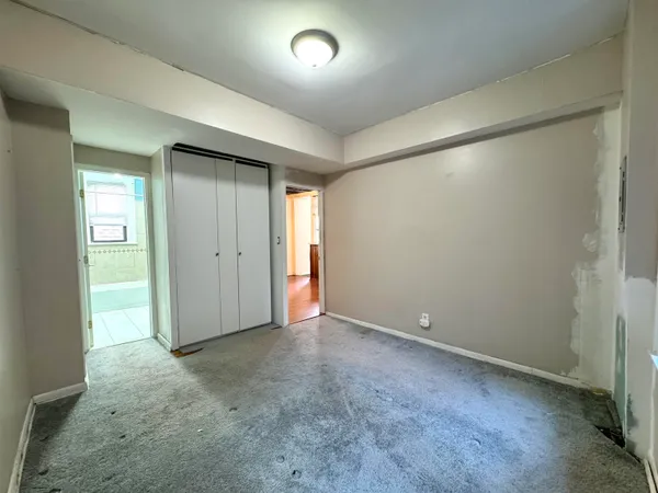 an empty room with closet area