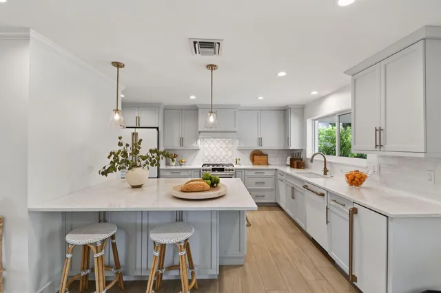a kitchen with a table chairs stove and cabinets