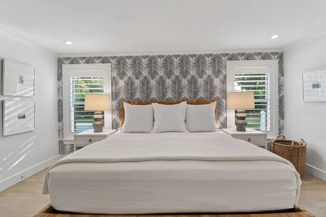 a bed room with a bed and a night stand