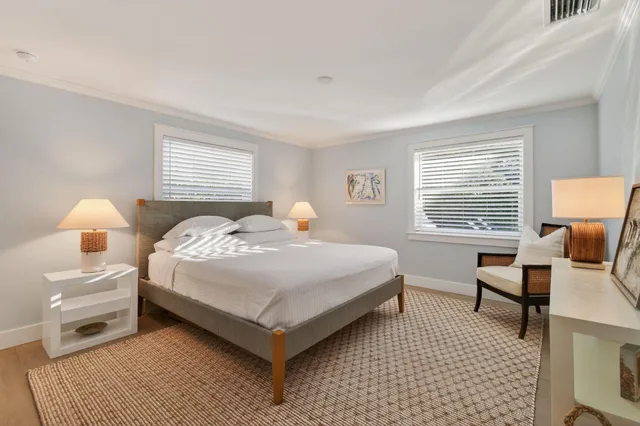 a bathroom with a double vanity sink toilet and a tub