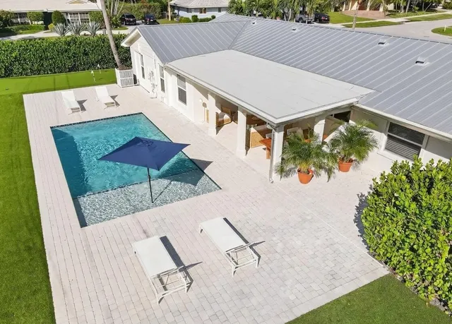 an aerial view of a house with a swimming pool
