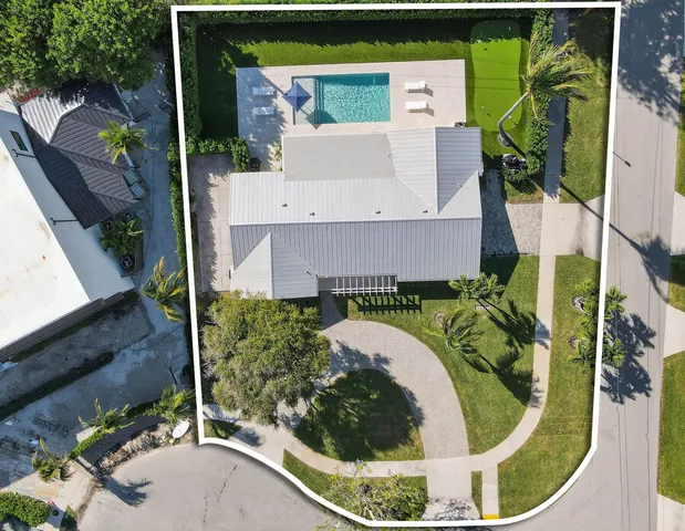 an aerial view of a house with a yard basket ball court