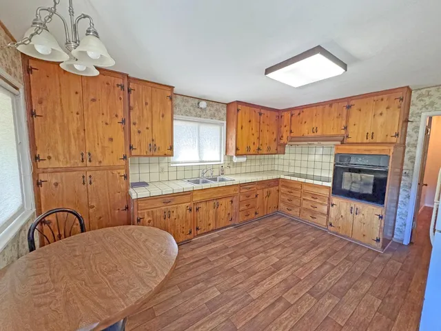 a dining room with furniture and wooden floor