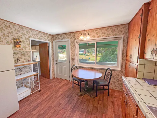 a view of a room with wooden floor and cabinet