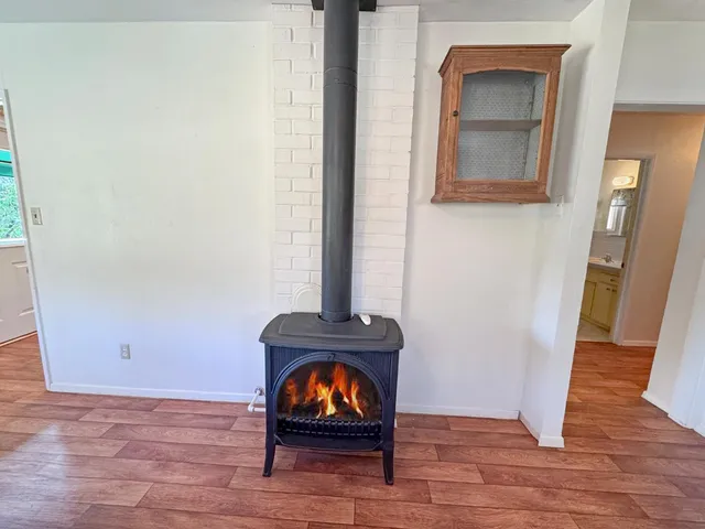 a view of a room with wooden floor and a window