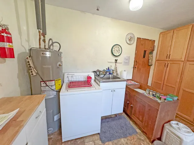 a living room with furniture fireplace and a large window