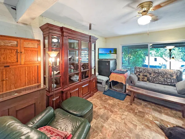 a bedroom with a bed window and mirror