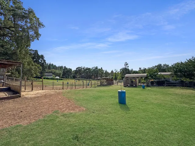 aerial view of a house with pool and a yard