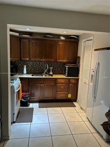 a kitchen with a refrigerator and a stove