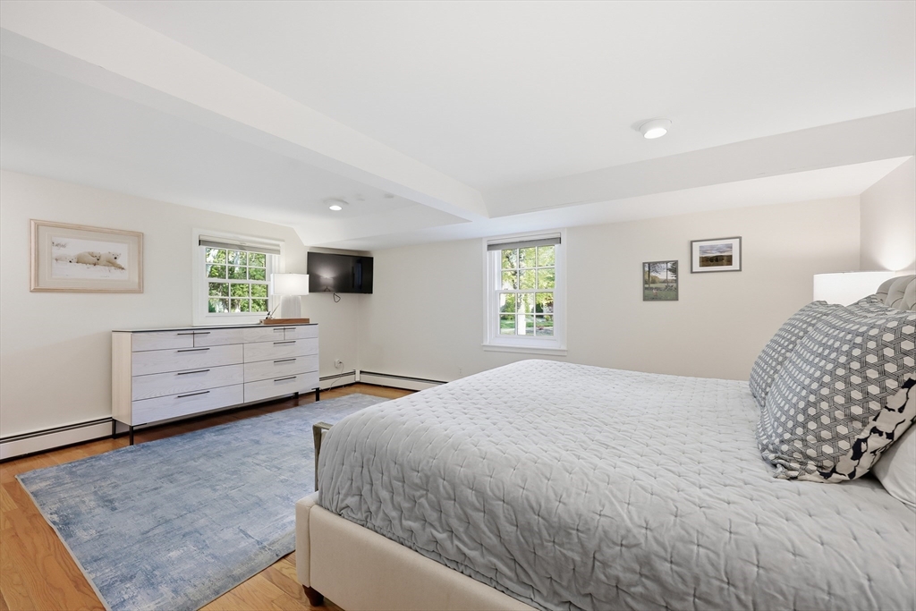123 Englewood Road Longmeadow, MA 01106 - Photo 18 of 42 a bedroom with a bed and wooden floor