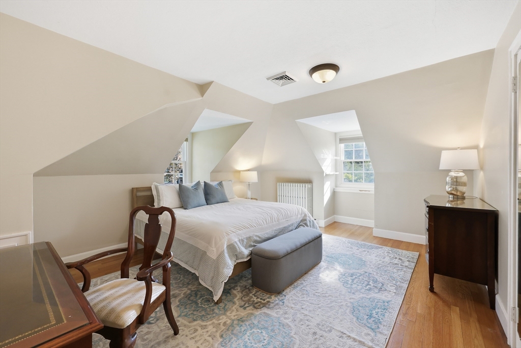 123 Englewood Road Longmeadow, MA 01106 - Photo 23 of 42 a bedroom with a bed and wooden floor