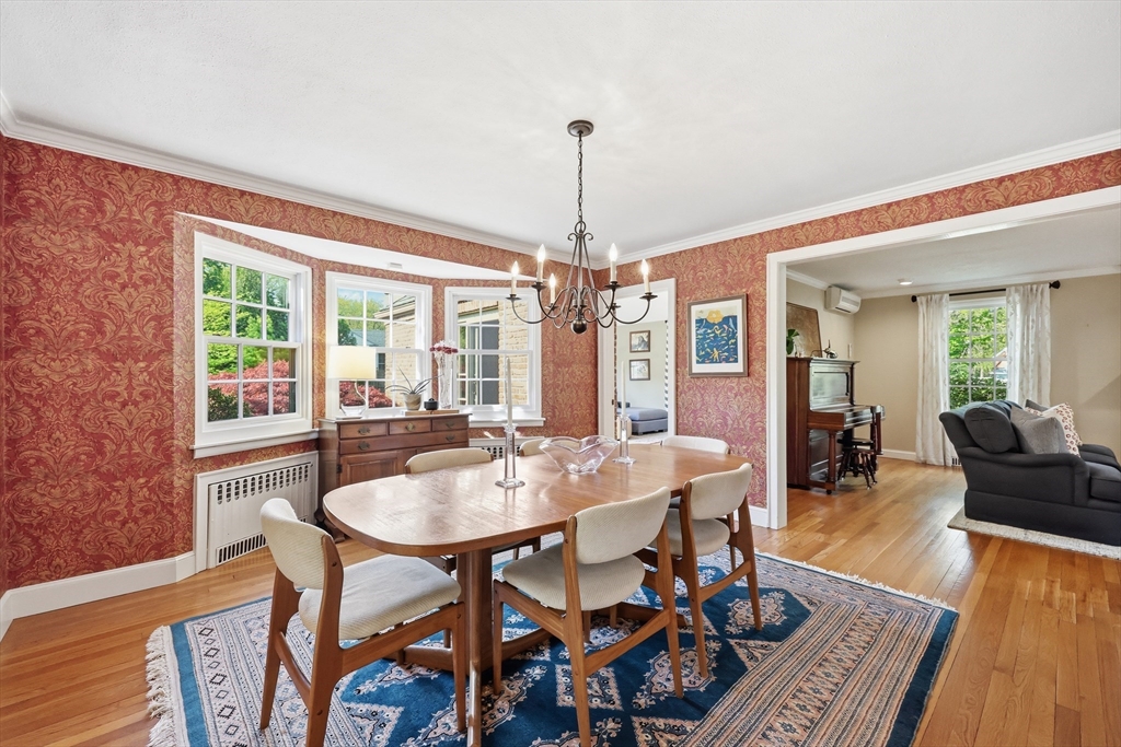 123 Englewood Road Longmeadow, MA 01106 - Photo 10 of 42 a dining room with furniture a chandelier and wooden floor