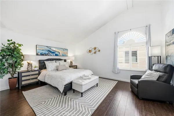 a bedroom with a bed and a couch