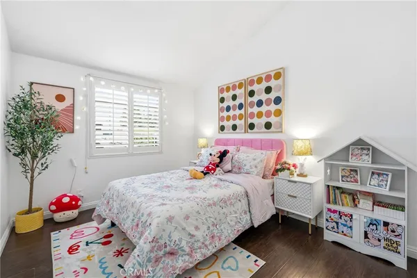 a bedroom with bed and a book shelf