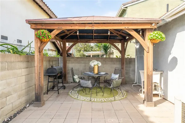 a view of patio with table and chairs