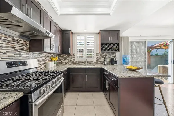 a kitchen with granite countertop stainless steel appliances and counter space