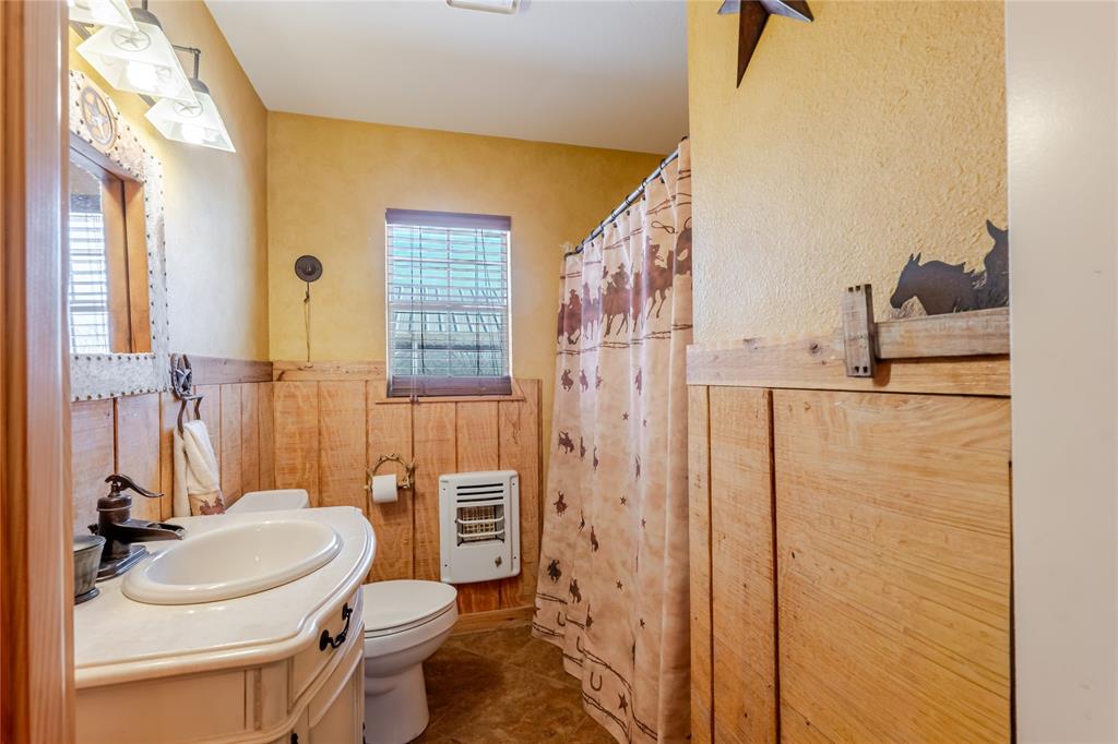 794 West Antelope Road, Unit 1 Windthorst, TX 76389 - Photo 15 of 40 a bathroom with a sink a toilet a mirror and shower