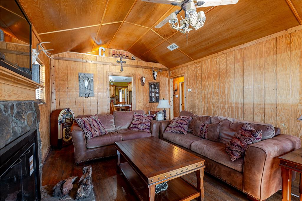 794 West Antelope Road, Unit 1 Windthorst, TX 76389 - Photo 9 of 40 a living room with furniture a couch and a chandelier