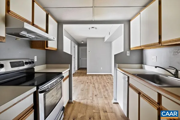 a kitchen that has a sink and a stove