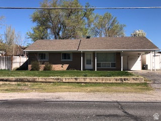 1615 Pioneer Road Draper, UT 84020 - Photo 2 of 13 Brick facade residence featuring a covered carport, attached garage, and asphalt shingle roof