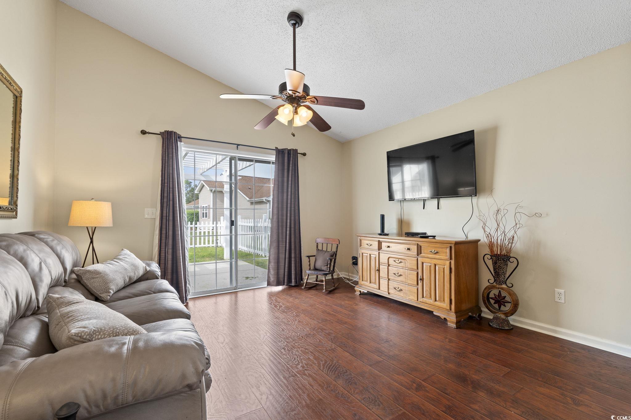 1130 Ganton Way Myrtle Beach, SC 29588 - Photo 10 of 30 Living area with baseboards, a ceiling fan, a textured ceiling, wood finished floors, and lofted ceiling