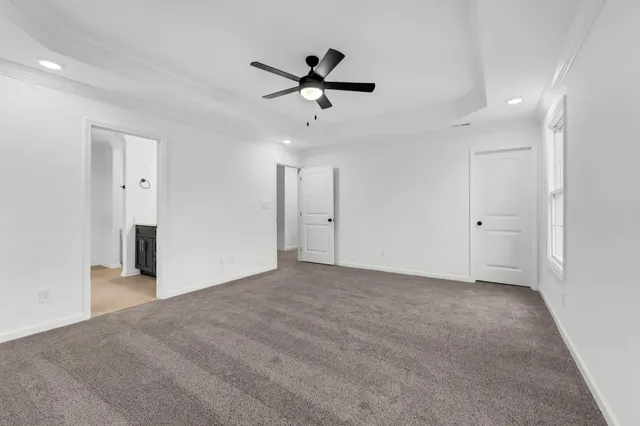 a view of an empty room with a ceiling fan