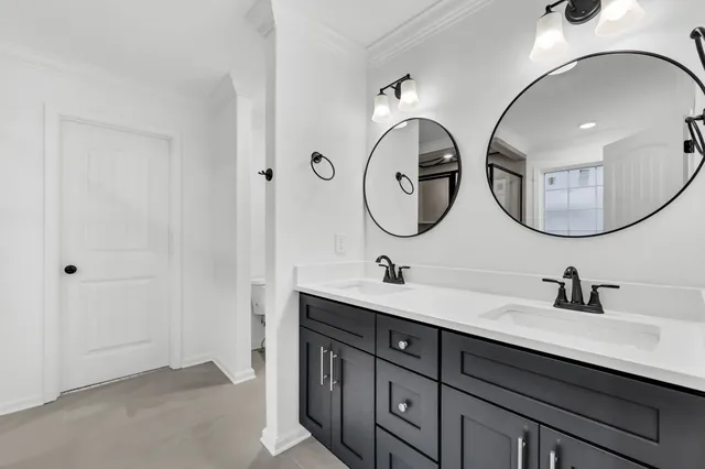 a bathroom with a double vanity sink and a mirror