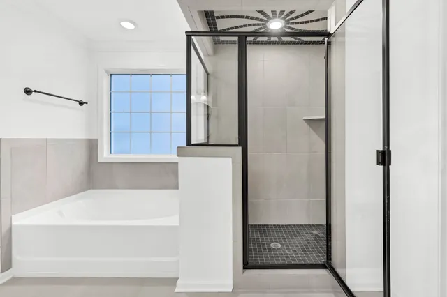 a bathroom with a bathtub and shower