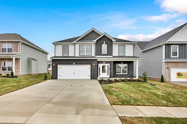 a front view of a house with a yard and garage