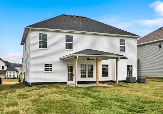 a view of a white house with a yard