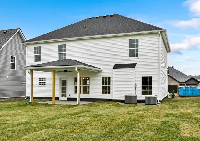 a view of a white house with yard