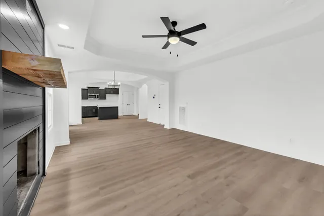 a view of a kitchen with a sink and a refrigerator