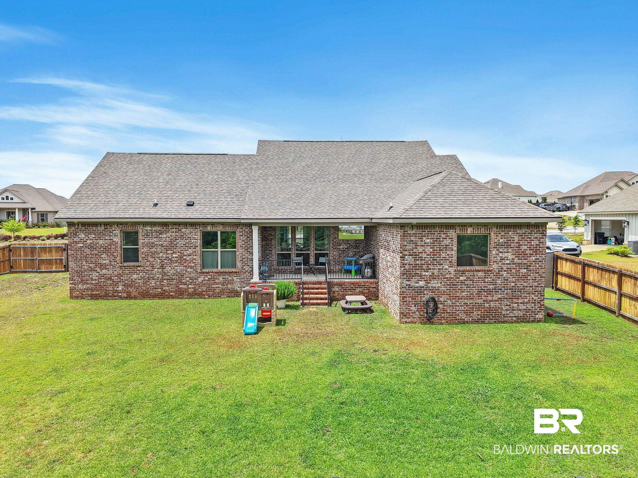 13233 Ibis Boulevard Daphne, AL 36527 - Photo 60 of 100 Brick exterior with a gabled roofline and a covered patio