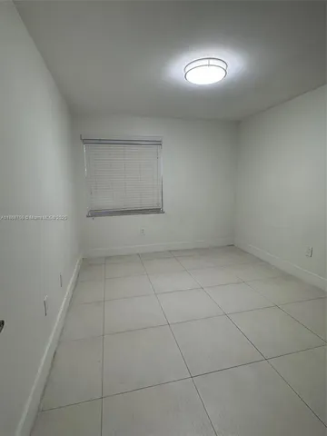 an empty room with a empty space and windows