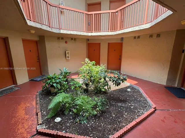 a view of a porch with potted plants