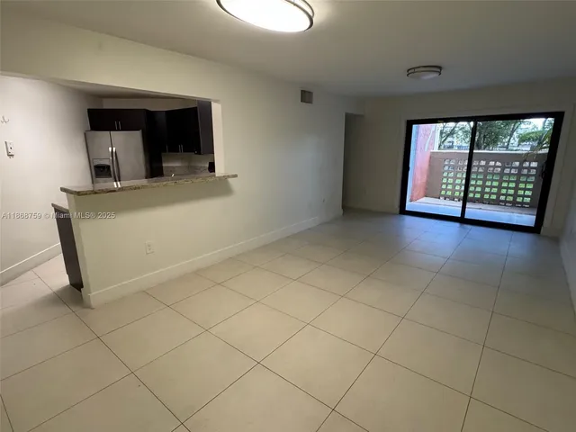 a view of an empty room with window and fireplace