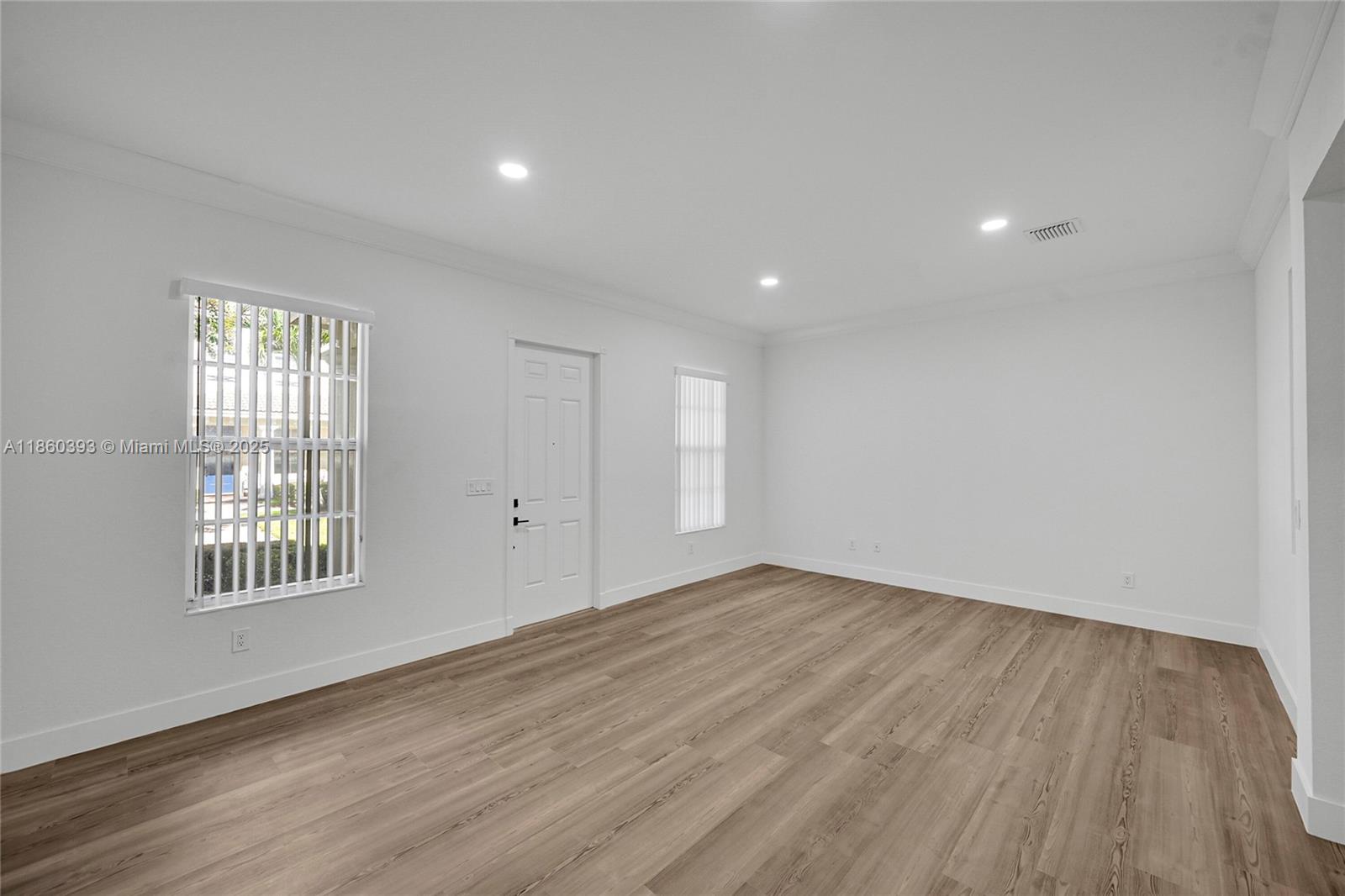 8305 Northwest 8th Terrace Boca Raton, FL 33487 - Photo 4 of 39 a view of an empty room with wooden floor and a window