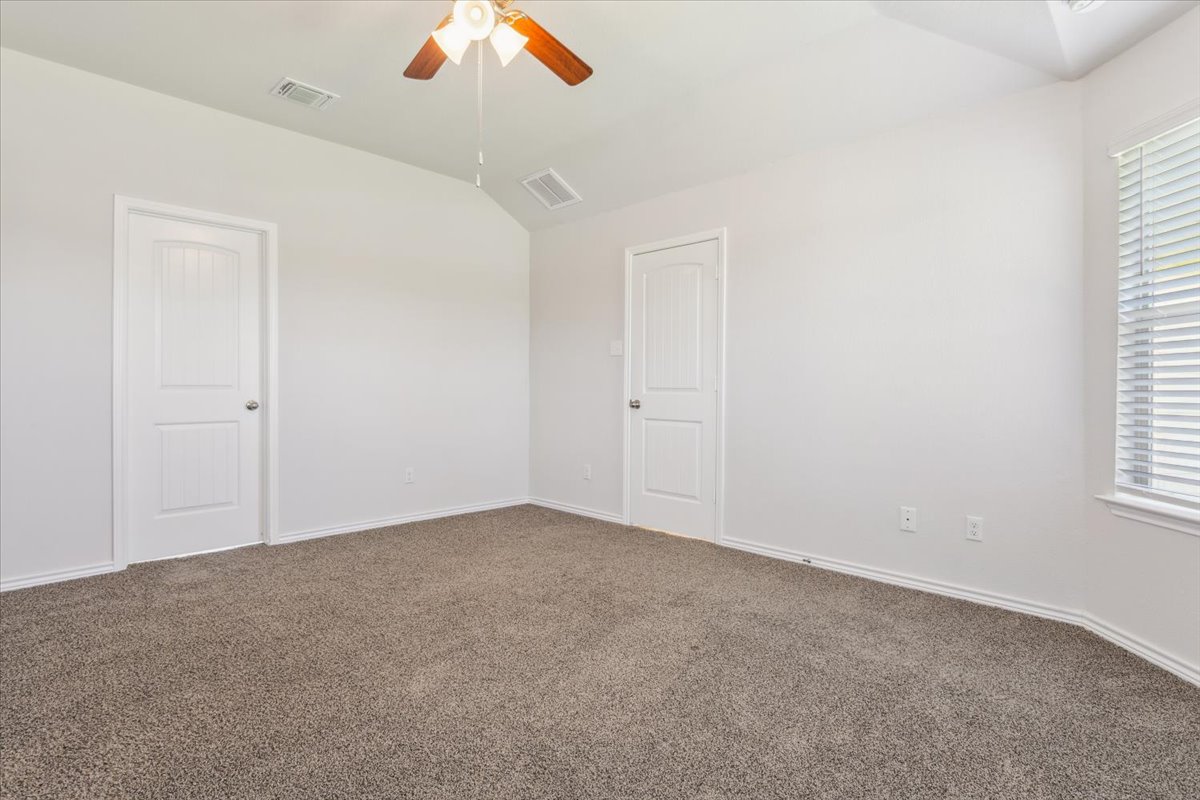 5830 Copano Road Belton, TX 76513 - Photo 20 of 34 Spare room with visible vents, vaulted ceiling, a ceiling fan, and carpet floors