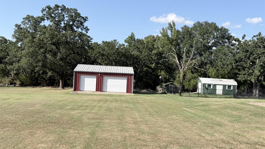 313 An County Road, Unit 2145 Palestine, TX 75801 - Photo 12 of 40 Two-bay red metal garage with white roll-up doors
