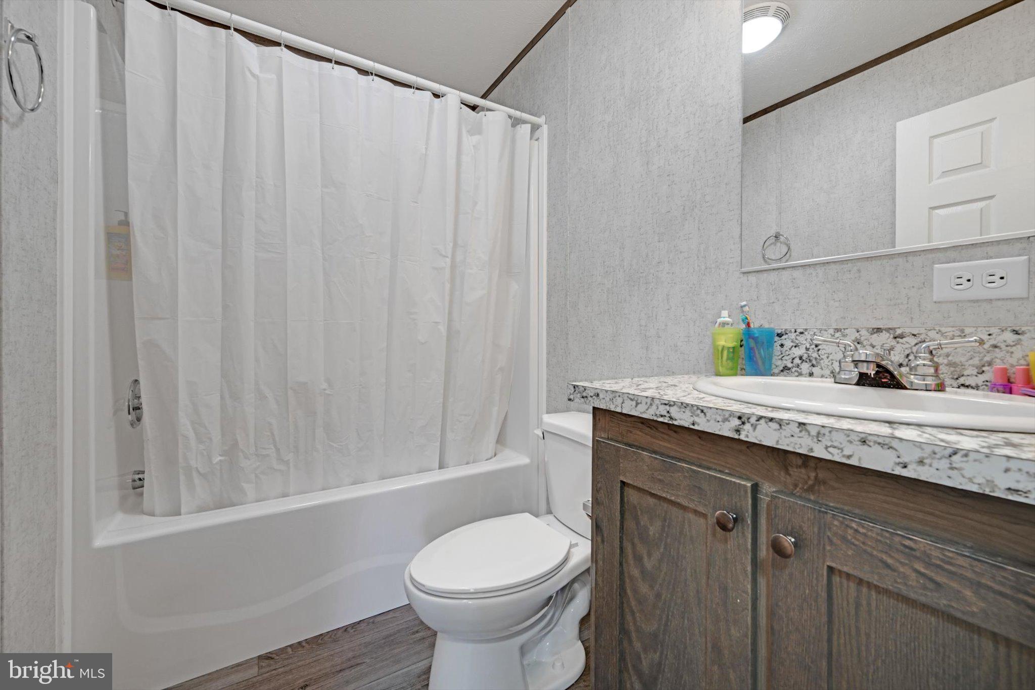38 Squaw Circle Barto, PA 19504 - Photo 23 of 26 a bathroom with a granite countertop sink and a toilet