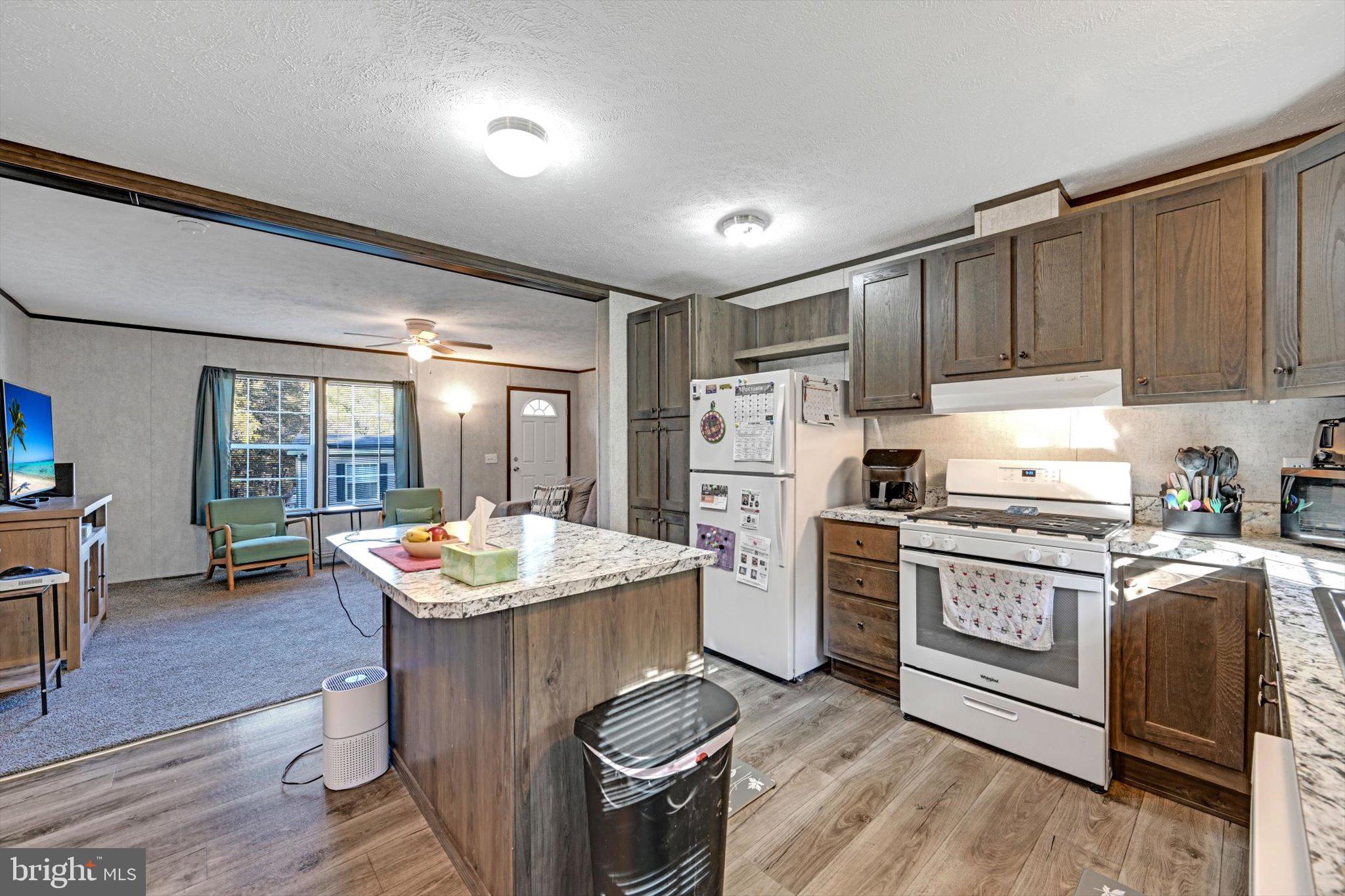 38 Squaw Circle Barto, PA 19504 - Photo 9 of 26 a kitchen with refrigerator a stove a sink dishwasher and cabinets with wooden floor
