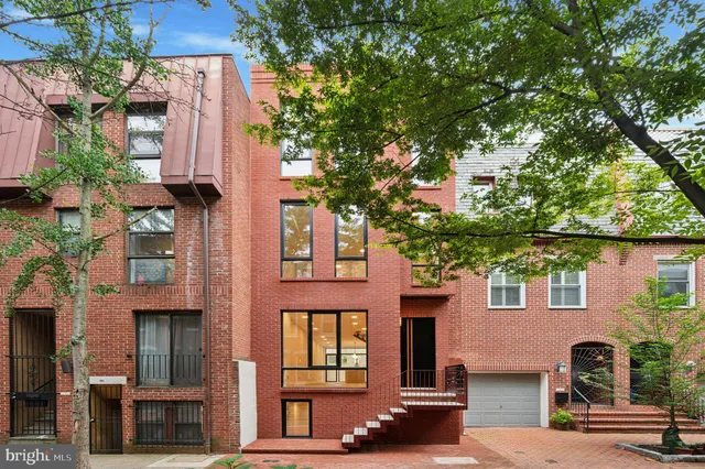 front view of a house with a tree